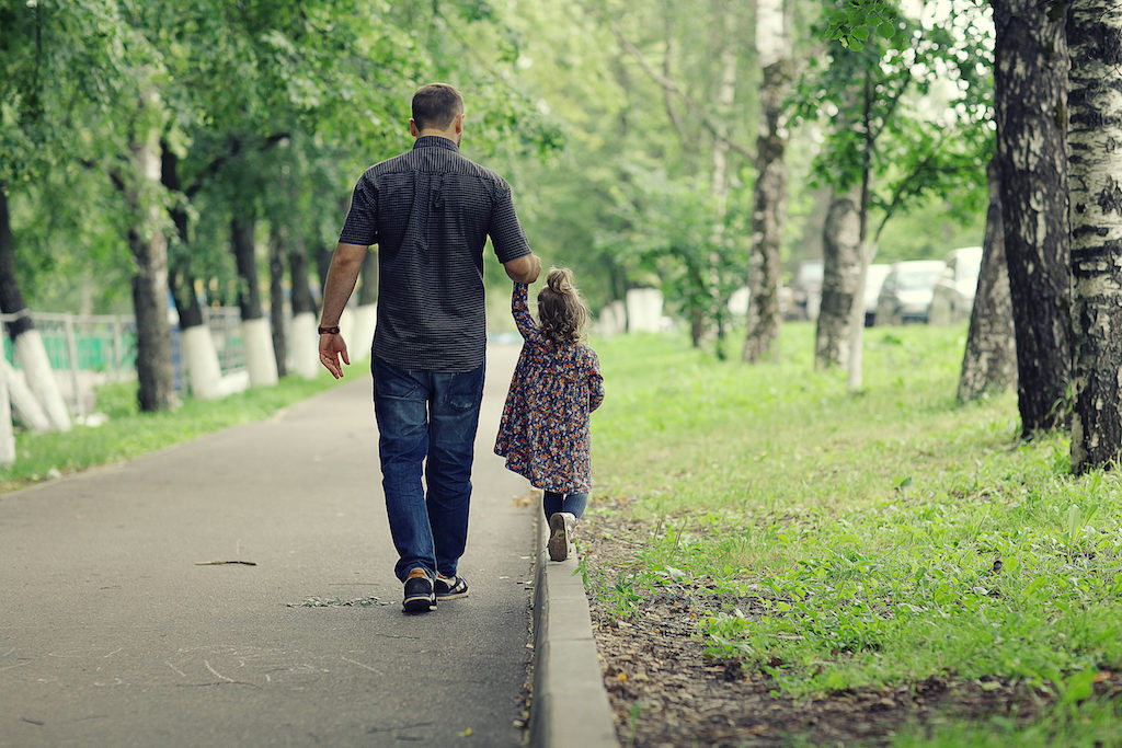 Father Walking with Daughter in Park